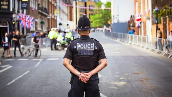 Police officer standing on the road.