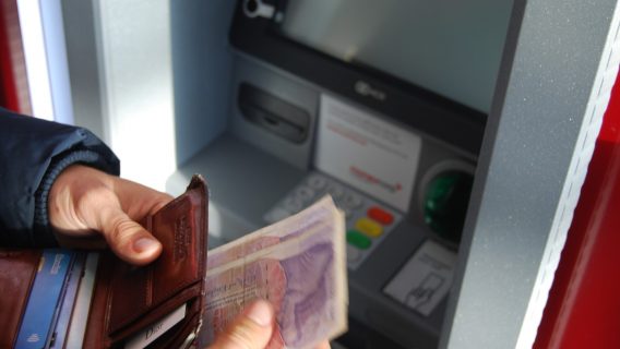 Person withdrawing money from UK ATM