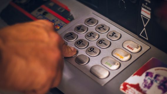 hand on pressing buttons in a ATM machine.