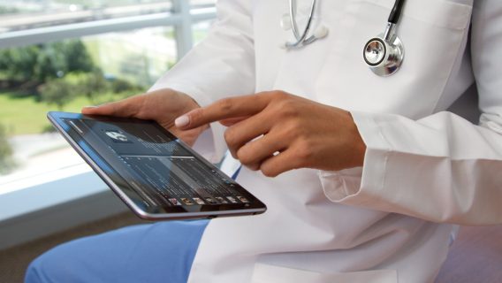 doctor accessing patient data through a tablet