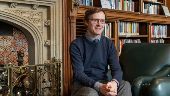 Carl, Head of the Social and General Statistics research section, sat by the fireplace in the House of Commons Library